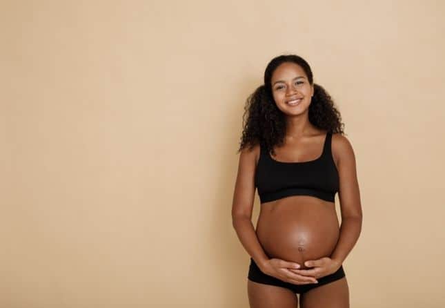 woman holding her pregnant belly