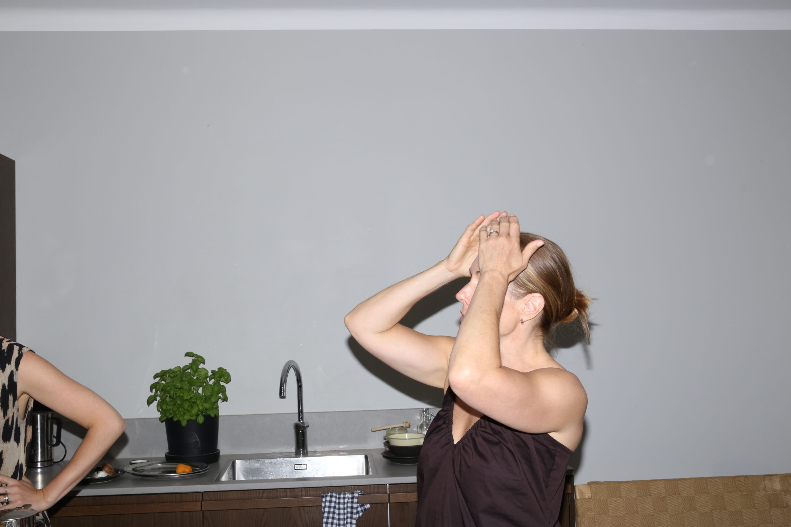 women putting her hands on the head